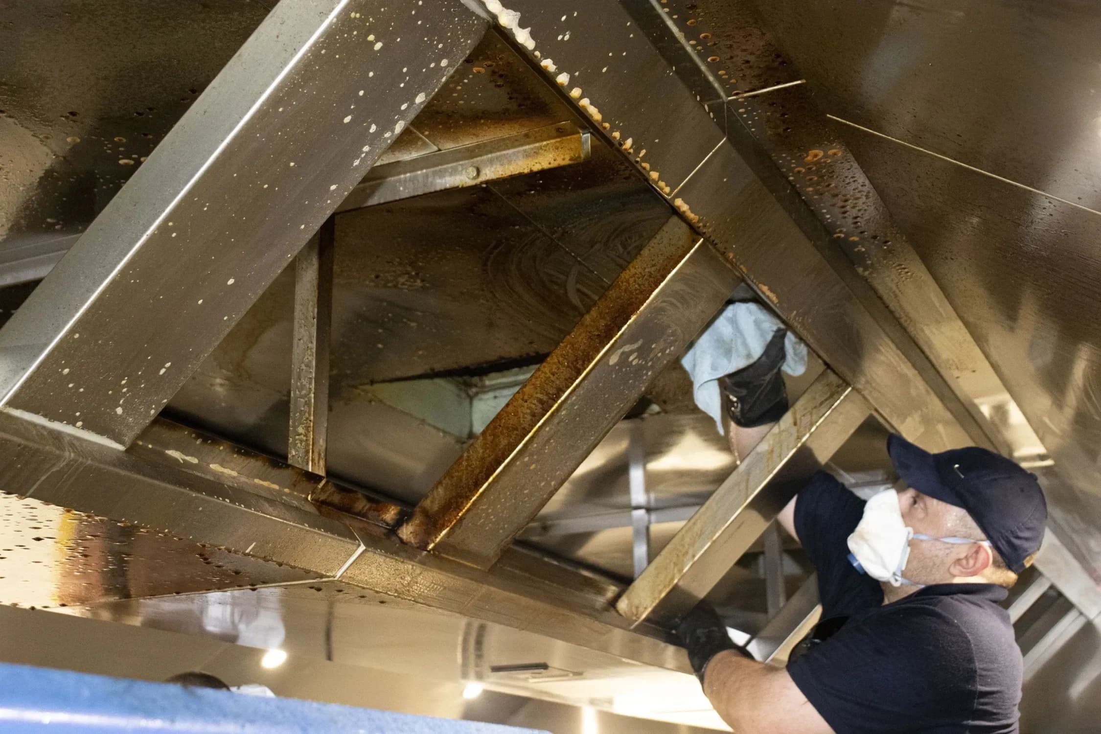 Bright team performing specialist canopy cleaning in an industrial kitchen.