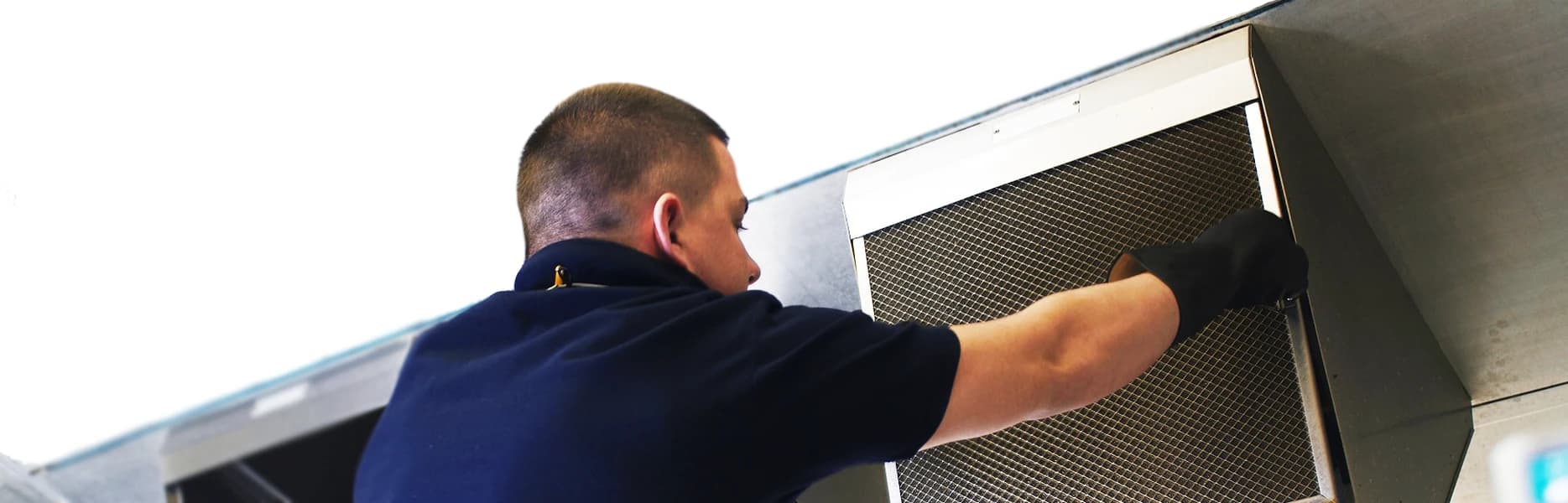 Bright team carrying out professional grease filter exchange service.