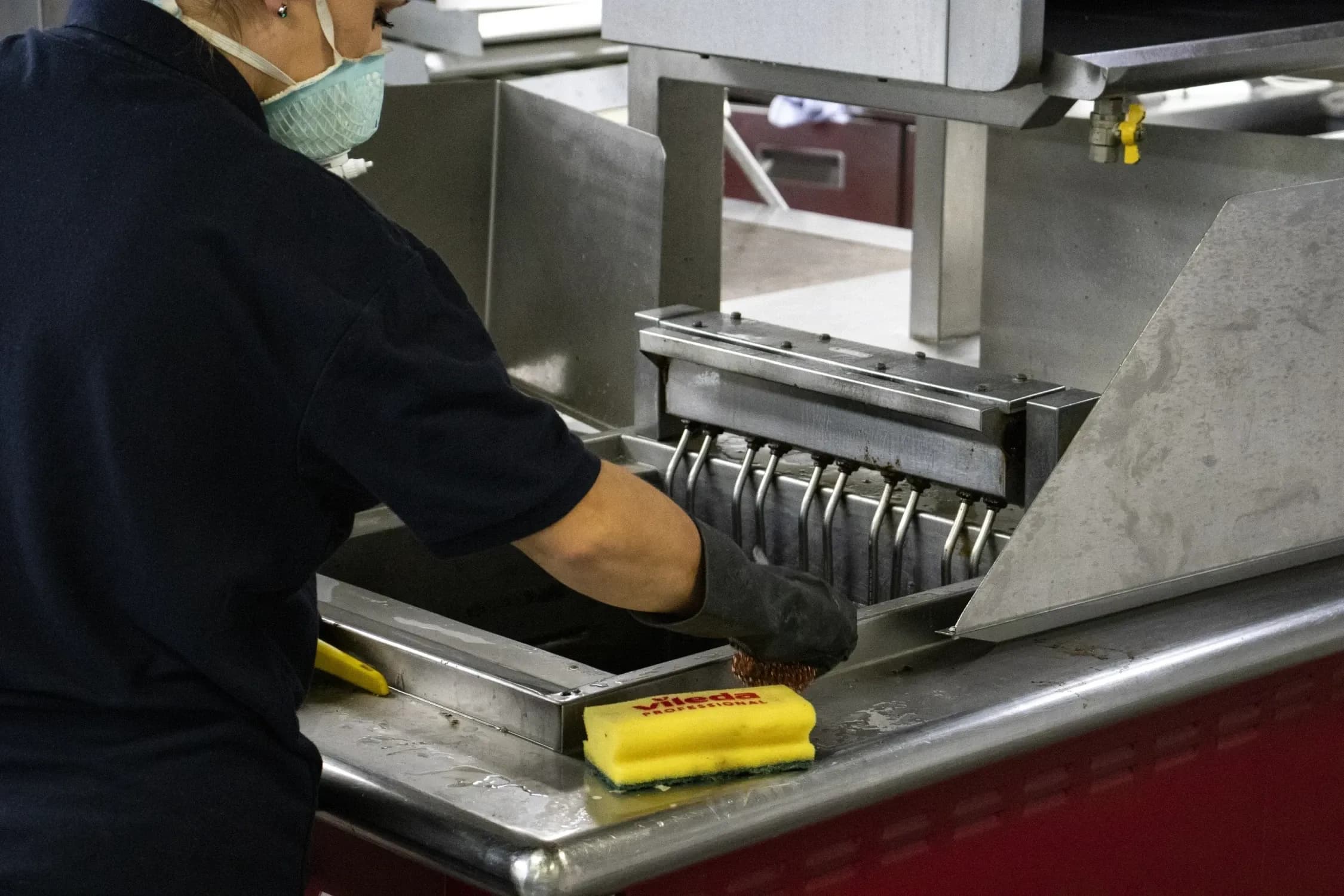 Bright team carrying out specialist deep cleaning of commercial kitchen equipment and surfaces.