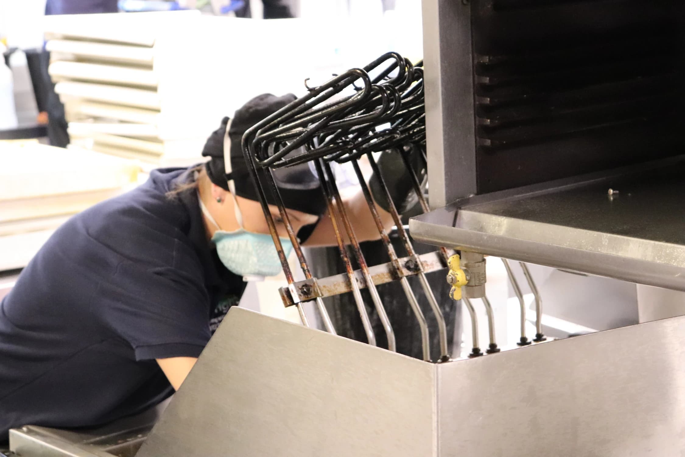 Bright technician carrying out specialist cleaning using sustainable methods in a secure site.