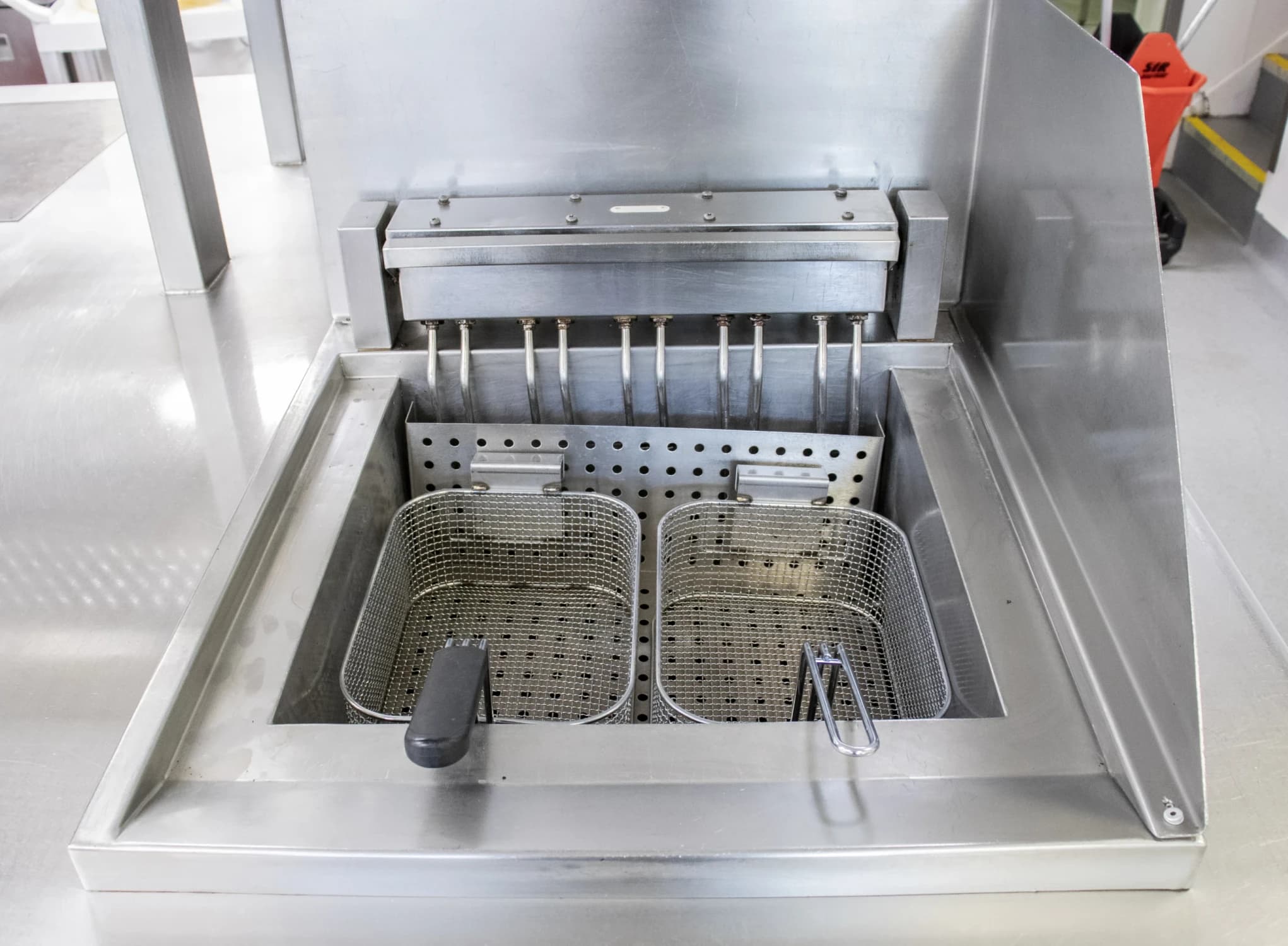 Professionally cleaned deep fat fryer in commercial kitchen for safe and compliant hospitality operations.