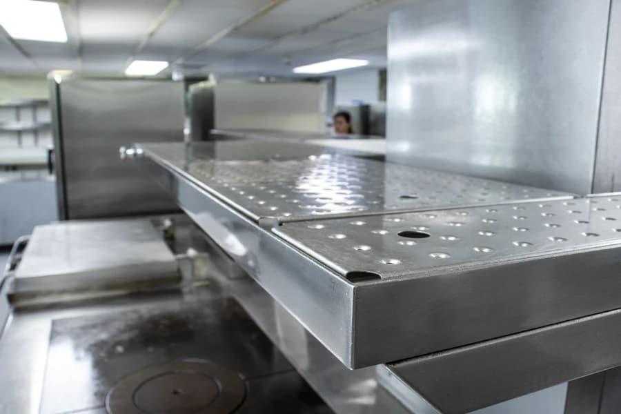 Industrial kitchen equipment professionally cleaned and maintained for hygiene compliance.